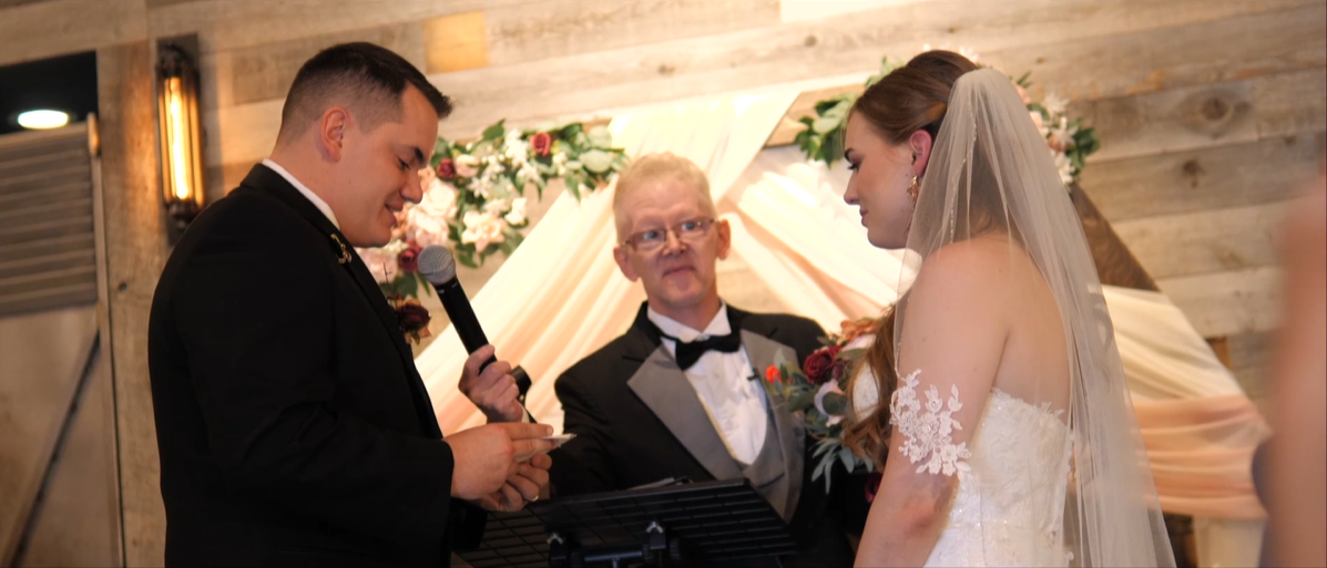 Couple stands at alter to exchange vows by Cydne Robinson Films